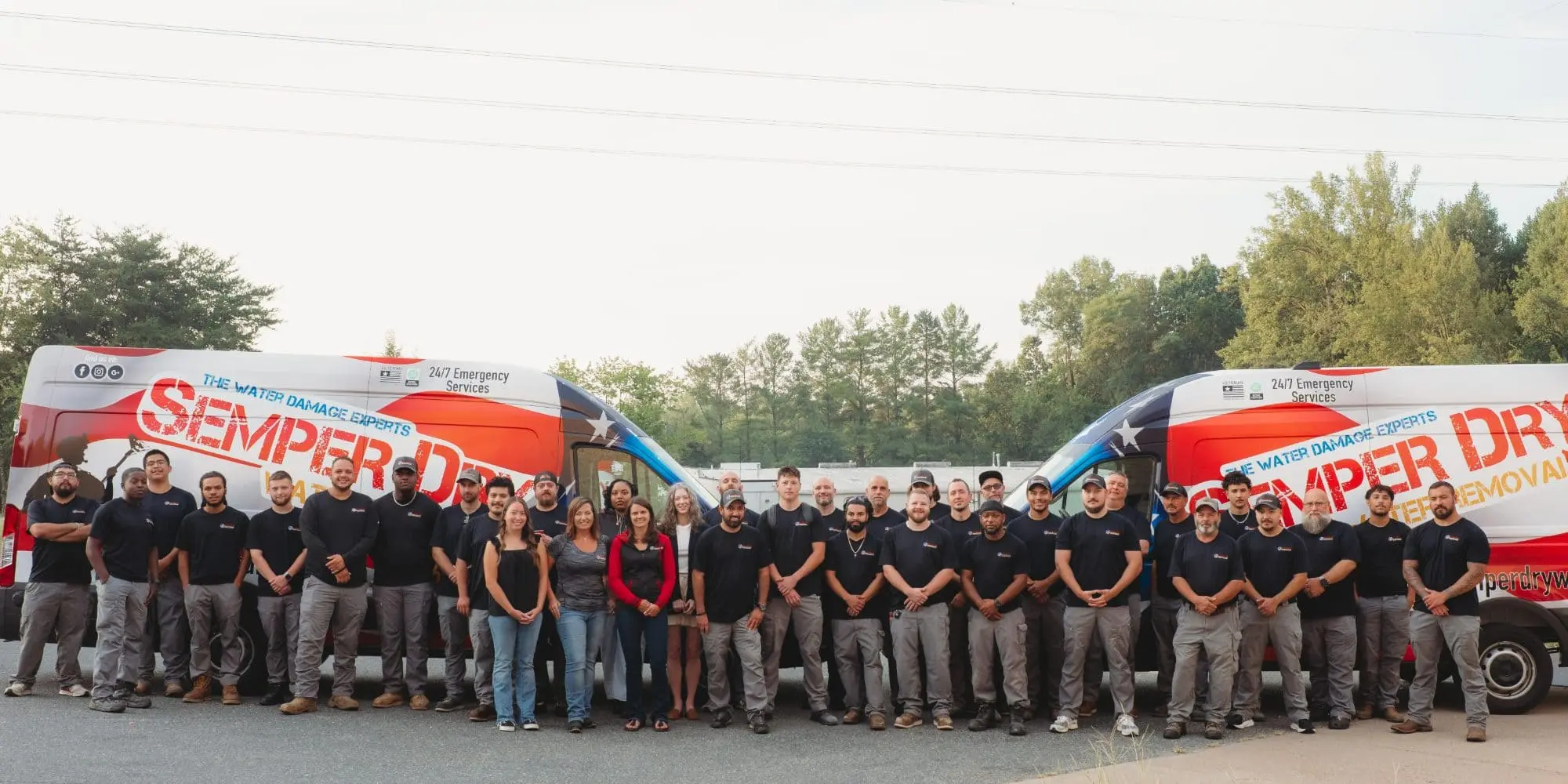 The full Semper Dry Water Removal team standing in front of two patriotic wrapped response vans in Fredericksburg, Virginia